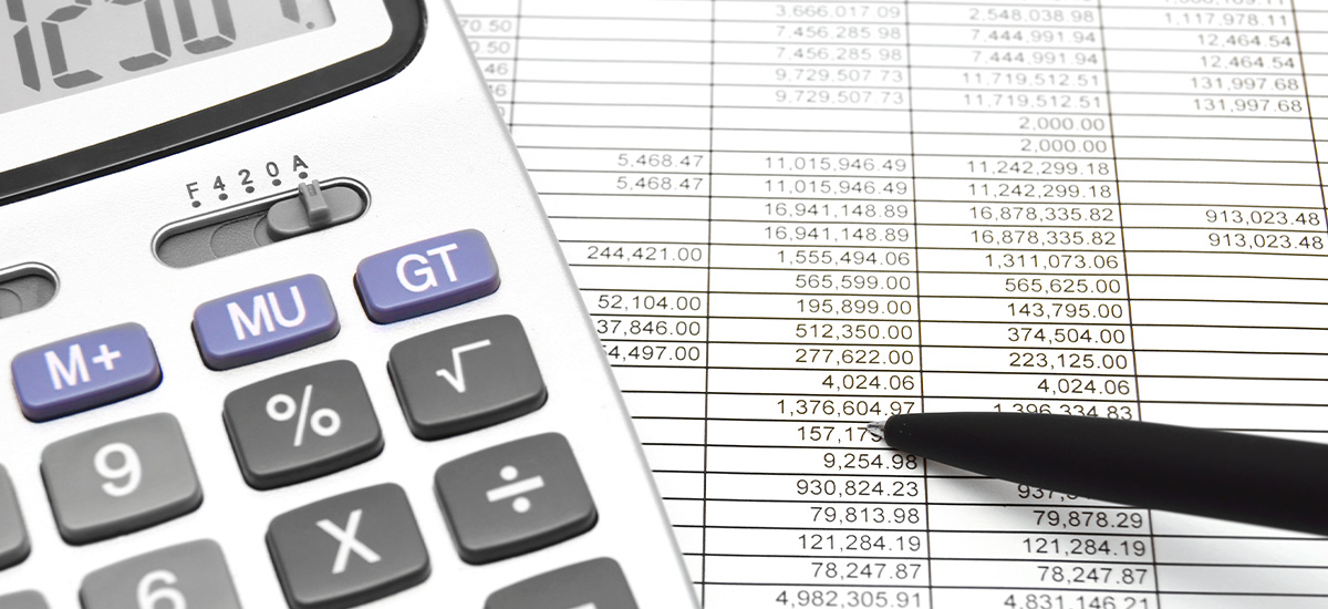 A calculator on top of a printed project estimation spreadsheet